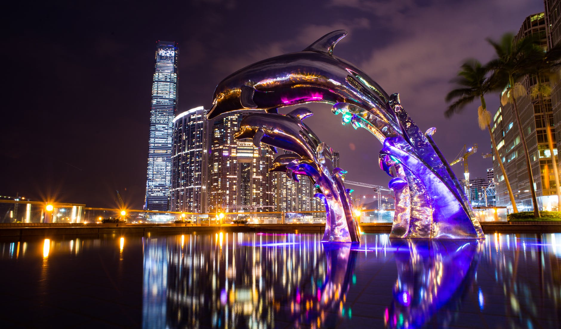 low angle photography of dolphin on fountain